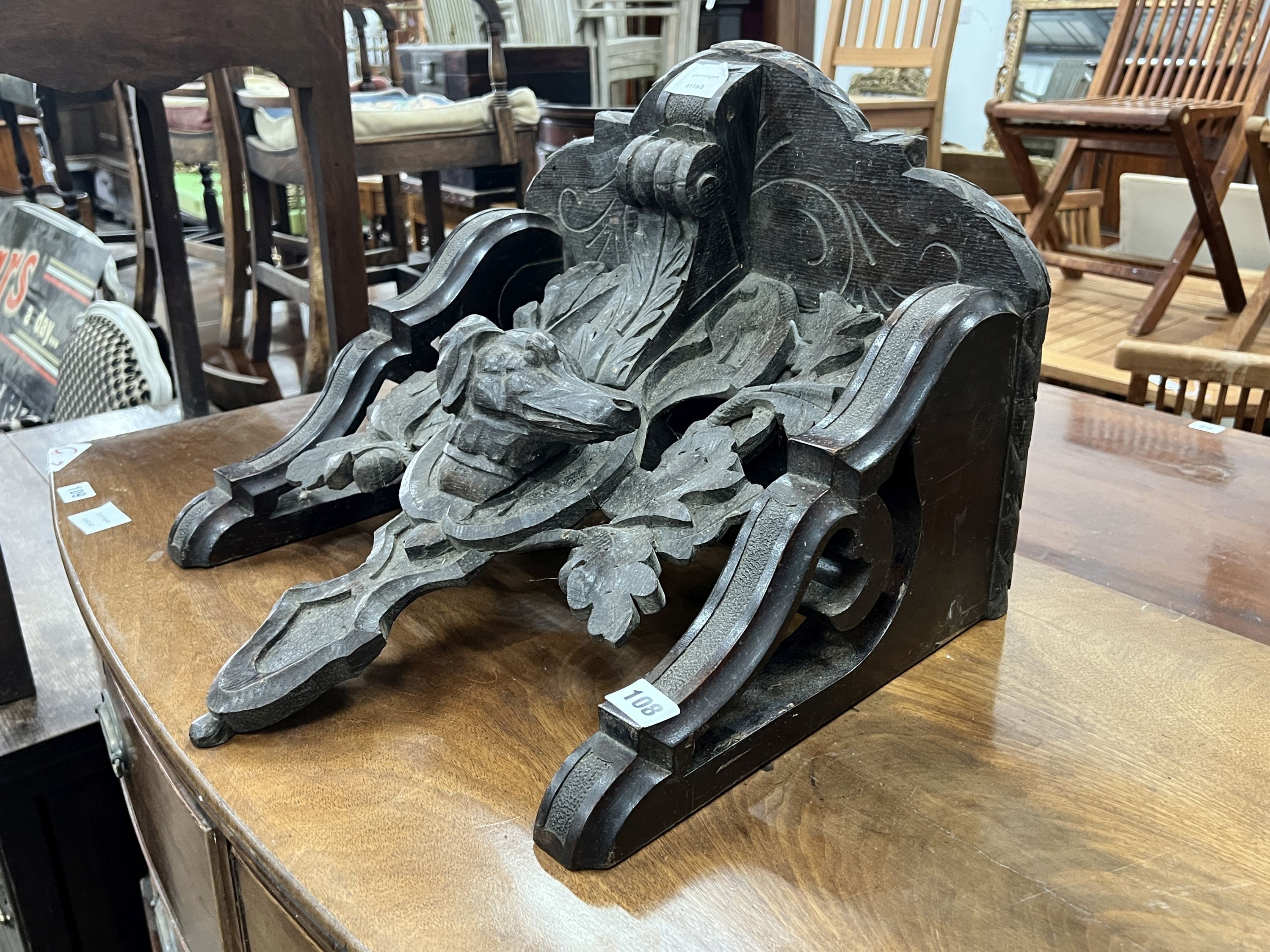A Victorian carved oak dog's head wall bracket, width 48cm, height 35cm